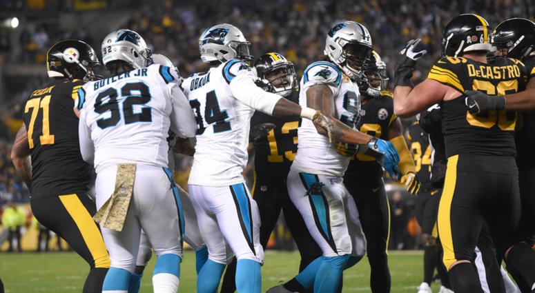 Players from the Pittsburgh Steelers and Carolina Panthers push and shove each other after a hit by Carolina safety Eric Reid against Pittsburgh quarterback Ben Roethlisberger during the third quarter