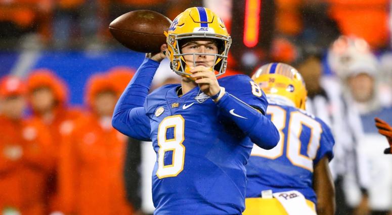 Pittsburgh Panthers quarterback Kenny Pickett (8) drops back to pass the ball in the first quarter against the Clemson Tigers in the ACC championship game at Bank of America Stadium.