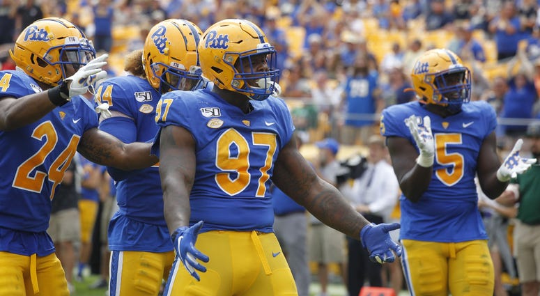 Pittsburgh Panthers linebacker Phil Campbell III (24) and linebacker Elias Reynolds (44) and defensive lineman Jaylen Twyman (97) and defensive lineman Deslin Alexandre (5) celebrate a defensive stop ...