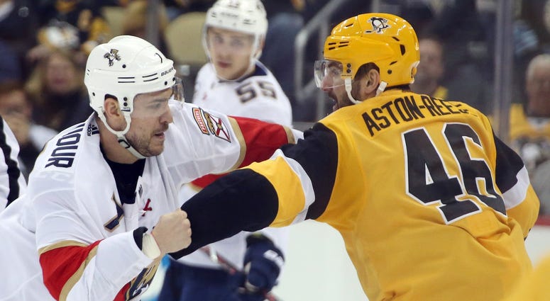 Pittsburgh Penguins center Zach Aston-Reese (46) and Florida Panthers center Colton Sceviour (7) fight during the third period at PPG PAINTS Arena. The Penguins won 5-1.