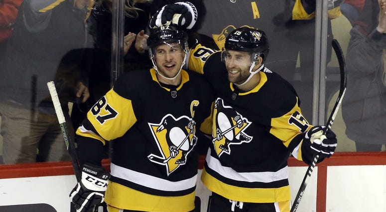 Pittsburgh Penguins left wing Jason Zucker (16) reacts with center Sidney Crosby (87) after scoring a goal against the Montreal Canadiens during the second period at PPG PAINTS Arena. Pittsburgh won 4...