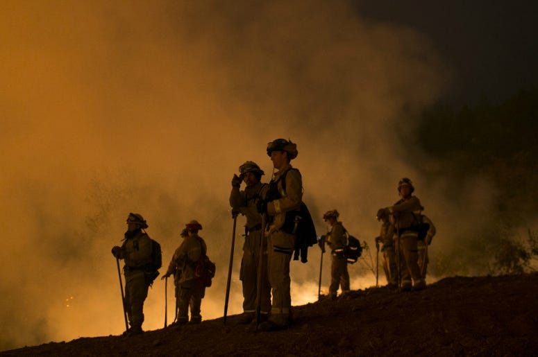 Firefighters hold a line in the Camp Fire with a control burn near Bloomer Hill in Butte County in California. Firefighters hold a line in the Camp Fire with a control burn near Bloomer Hill in Butte County in California.