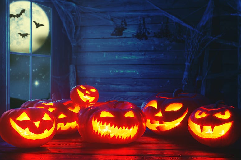 Spooky halloween background. scary pumpkin with burning eyes Spooky halloween background. scary pumpkin with burning eyes