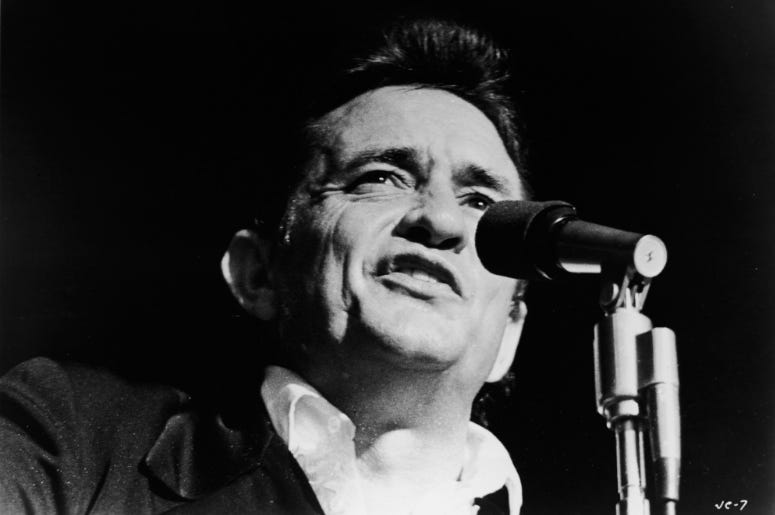 Johnny Cash (1932 - 2003) singing on stage in a still from the film, 'Johnny Cash - The Man, His World, His Music,' directed by Robert Elfstrom, 1969. Johnny Cash (1932 - 2003) singing on stage in a still from the film, 'Johnny Cash - The Man, His World, His Music,' directed by Robert Elfstrom, 1969.
