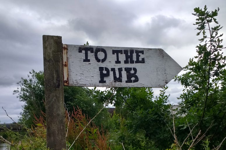 A sign pointing the way to the pub