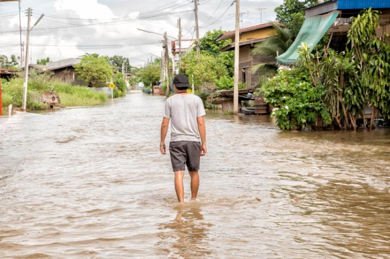 man walking through high water