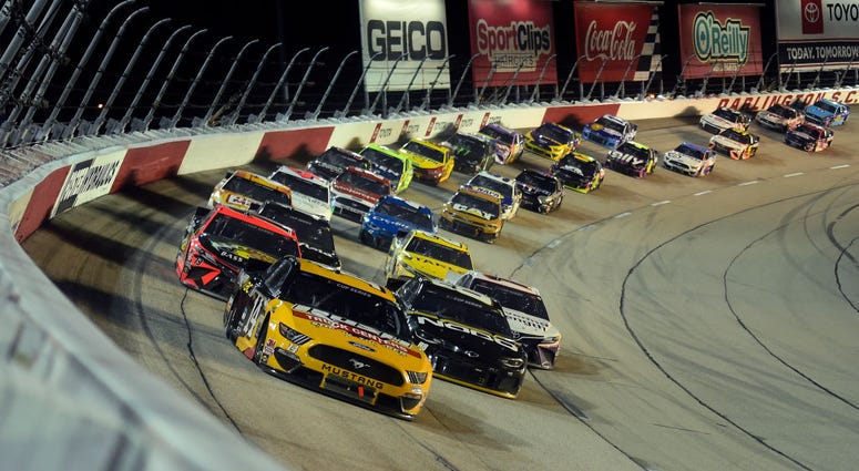 A NASCAR race and a graduation parade on a Wednesday