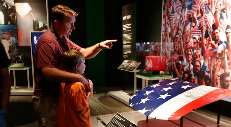 Visitors to the National September 11 Memorial & Museum view the "Comeback Season: Sports After 9/11" exhibit.