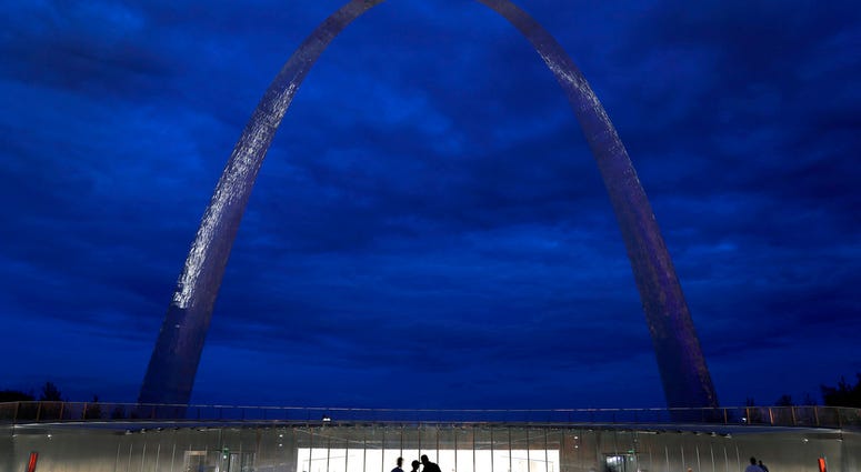 FILE - In this June 20, 2018, file photo, visitors stand outside a new entrance below the Gateway Arch in St. Louis.