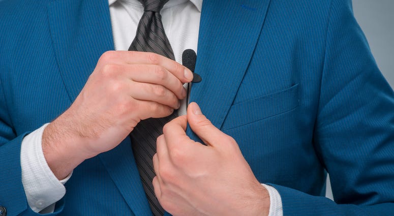 newscaster adjusting microphone