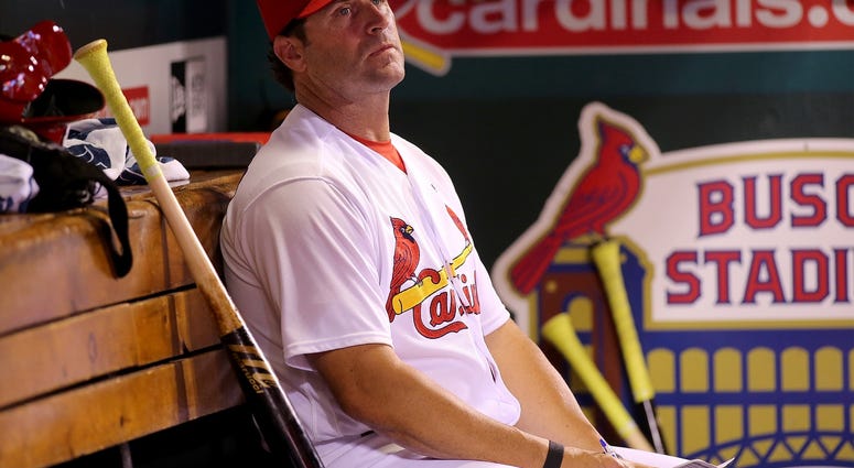 Caption: Jun 6, 2018; St. Louis, MO, USA; St. Louis Cardinals manager Mike Matheny (22) watches from the dugout during the sixth inning against the Miami Marlins at Busch Stadium.