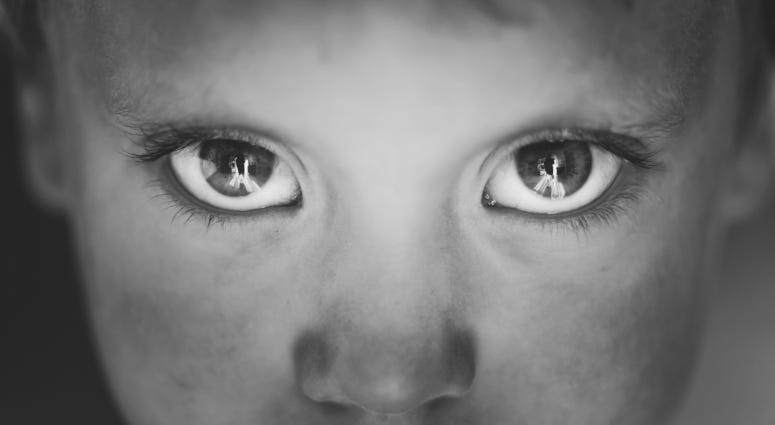 close up of child's eyes in grayscale