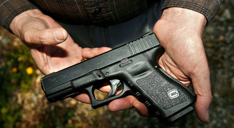 hands holding gun