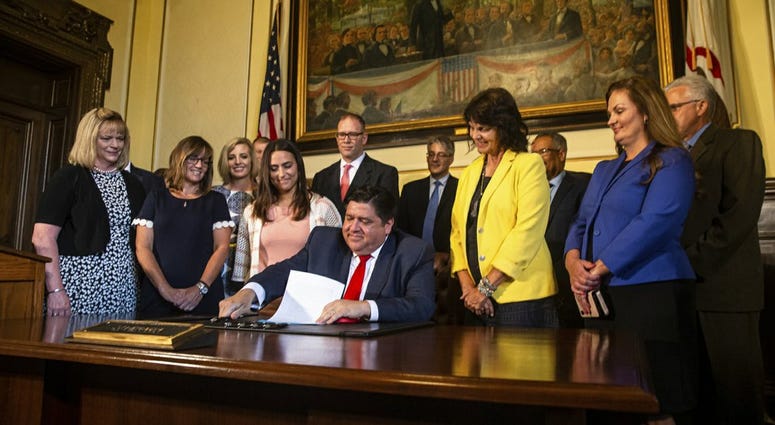 Pritzker signs teacher salary legislation