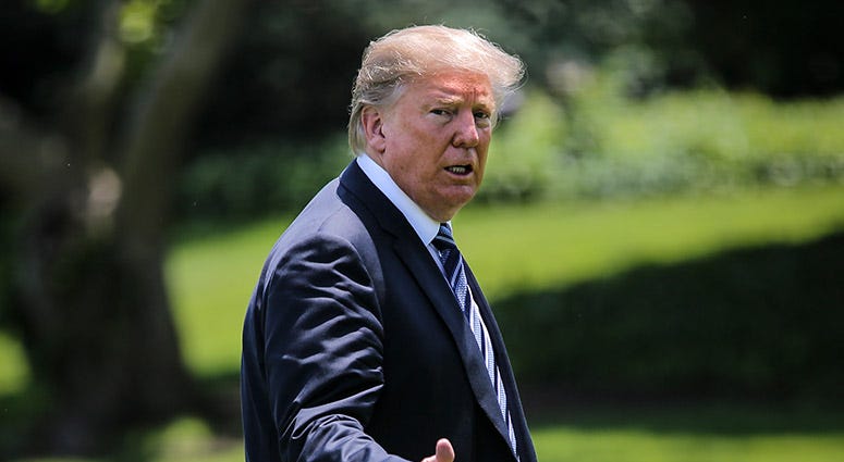 President Donald Trump gestures as he arrives to the White House on May 25, 2018 in Washington, DC.
