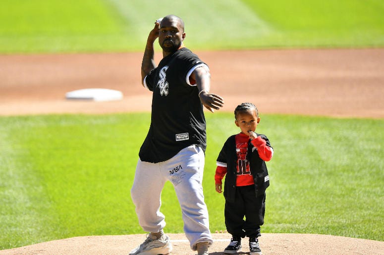 Kanye West and his son Saint throw out a ceremonial first pitch before the game between the Chicago White Sox and the Chicago Cubs at Guaranteed Rate Field Kanye West and his son Saint throw out a ceremonial first pitch before the game between the Chicago White Sox and the Chicago Cubs at Guaranteed Rate Field
