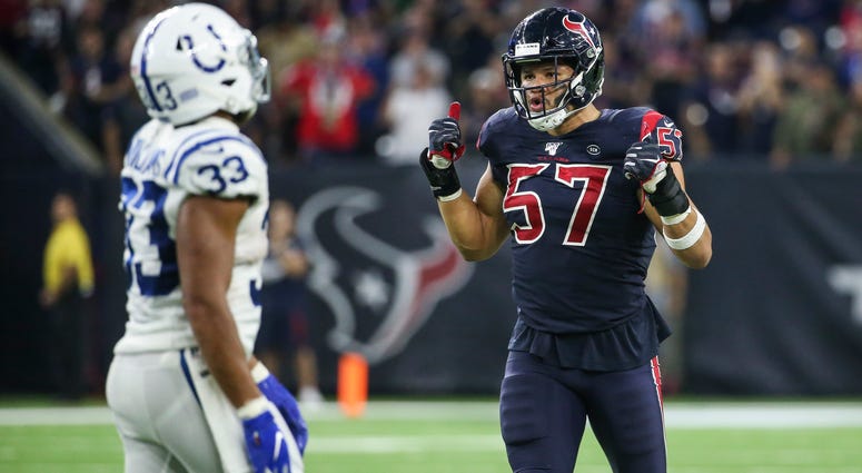 Houston Texans outside linebacker Brennan Scarlett (57) and Indianapolis Colts running back Jonathan Williams (33) react after a play during the fourth quarter at NRG Stadium.
