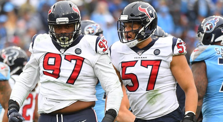 Houston Texans defensive end Angelo Blackson (97) and Houston Texans outside linebacker Brennan Scarlett (57) after a stop on a run from Tennessee Titans running back Derrick Henry (22) during the second half at Nissan Stadium.