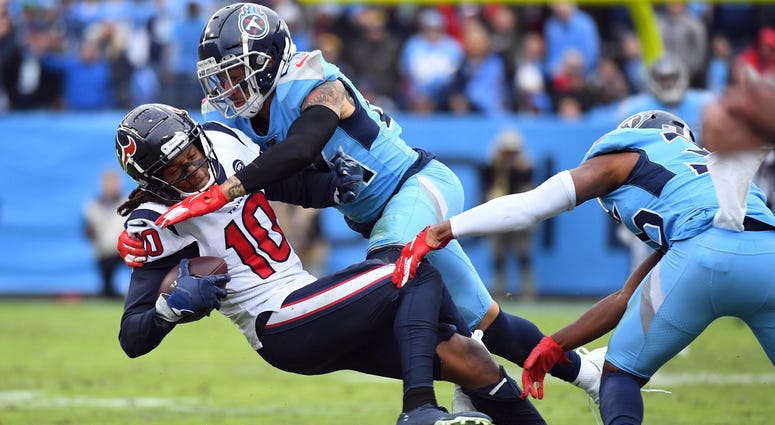 Houston Texans wide receiver DeAndre Hopkins (10) is tackled by Tennessee Titans strong safety Kenny Vaccaro (24) after a catch during the second half at Nissan Stadium.