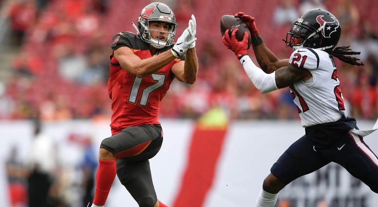 Houston Texans cornerback Bradley Roby (21) makes an interception on a pass intended for Tampa Bay Buccaneers wide receiver Justin Watson (17) and runs the ball in for a touchdown.