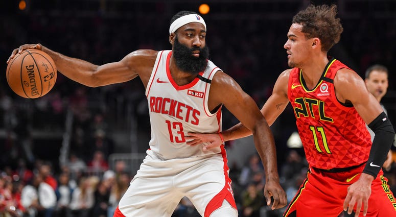 Houston Rockets guard James Harden (13) works against shoots Atlanta Hawks guard Trae Young (11) during the first half at State Farm Arena.