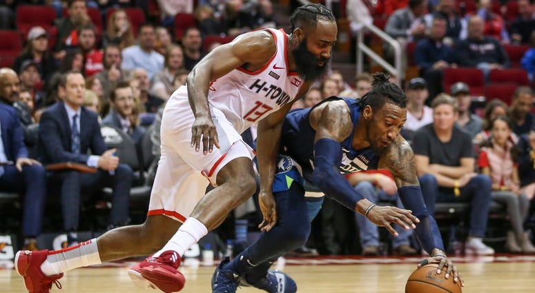 Houston Rockets guard James Harden (13) and Minnesota Timberwolves forward Robert Covington (33) attempt to get a loose ball during the second quarter at Toyota Center.