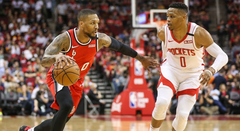 Portland Trail Blazers guard Damian Lillard (left) dribbles the ball against Houston Rockets guard Russell Westbrook (right) during the first quarter at Toyota Center.