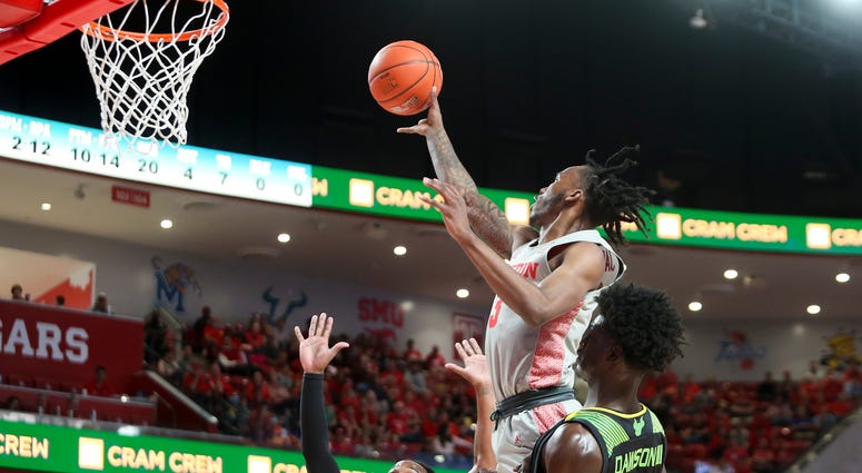 Houston Cougars guard DeJon Jarreau (3) goes up for a shot over South Florida Bulls guard Laquincy Rideau (3) during the second half at Fertitta Center.