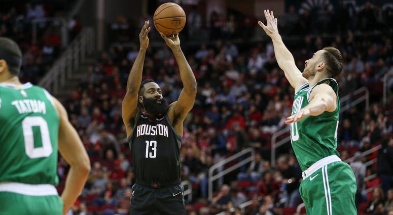 Houston Rockets guard James Harden (13) shoots the ball as Boston Celtics forward Gordon Hayward (20) defends during the first quarter at Toyota Center.