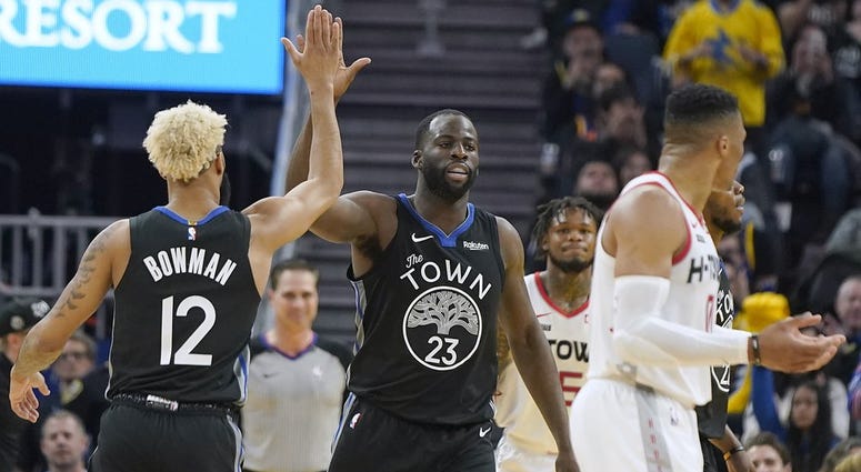 olden State Warriors forward Draymond Green (23) is congratulated by Ky Bowman (12) after scoring against the Houston Rockets during the first half of an NBA basketball game in San Francisco, Wednesday, Dec. 25, 2019.