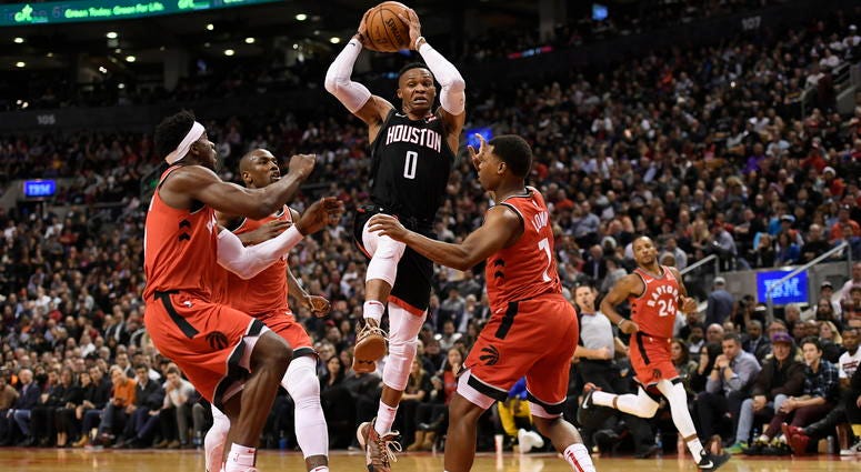 ouston Rockets guard Russell Westbrook (0) controls the ball between Toronto Raptors' defenders, left to right, Terence Davis, Serge Ibaka and Kyle Lowry during second half NBA action in Toronto on Thursday, Dec. 5, 2019.