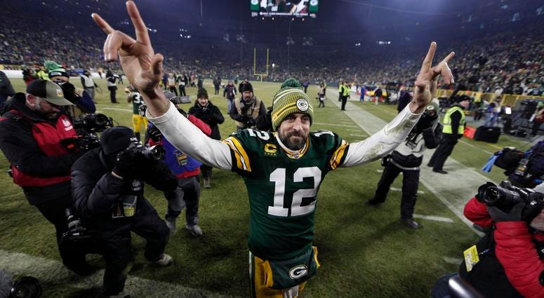 Green Bay Packers quarterback Aaron Rodgers (12) waves as he walks off the field after defeating the Seattle Seahawks in a NFC Divisional Round playoff football game at Lambeau Field.