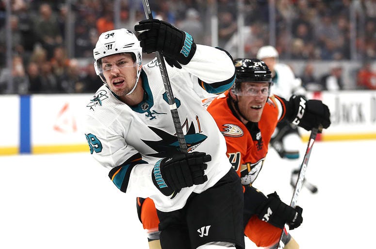 Logan Couture #39 of the San Jose Sharks ANAHEIM, CALIFORNIA - OCTOBER 05: Logan Couture #39 of the San Jose Sharks eludes the defense of Carter Rowney #24 of the Anaheim Ducks during the second period of a game at Honda Center on October 05, 2019 in Anaheim, California. (Photo by Sean M. Haffey