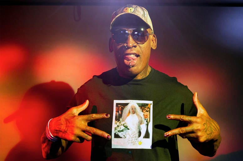 AP19253410851019 In this Monday, Sept. 9, 2019, photo, former NBA star Dennis Rodman poses wearing a T-shirt depicting himself in a wedding dress at a 1996 book promo event, in Los Angeles. (AP Photo/Damian Dovarganes)
