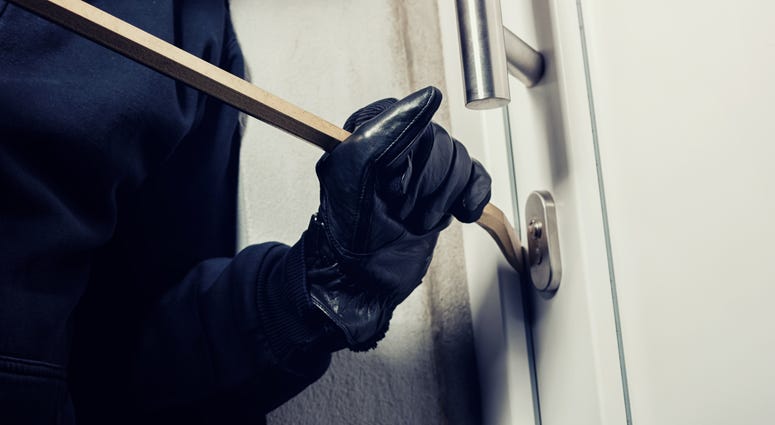 opening a door with a crow bar