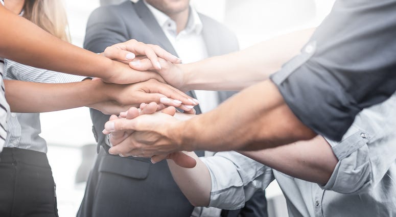 all in team handshake at work