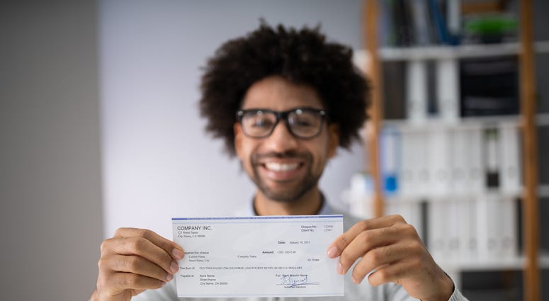 man holding a paycheck