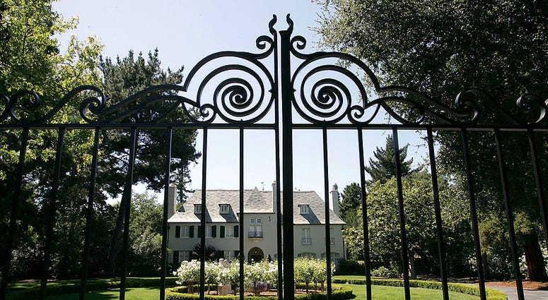 big house behind an iron gate