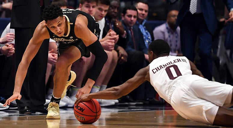 Vanderbilt Commodores forward Matthew Moyer (13) and Texas A&M Aggies guard Jay Jay Chandler (0) battle for a loose ball during the first half of the SEC conference tournament at Bridgestone Arena. Vanderbilt Commodores forward Matthew Moyer (13) and Texas A&M Aggies guard Jay Jay Chandler (0) battle for a loose ball during the first half of the SEC conference tournament at Bridgestone Arena.