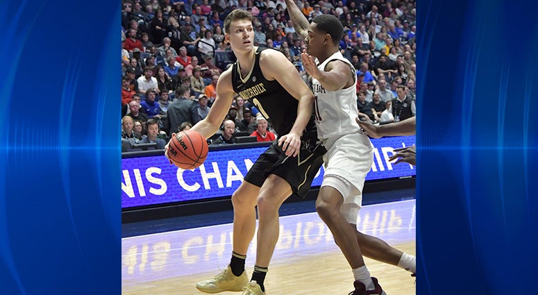 Vanderbilt Commodores forward Yanni Wetzell (1) is defended by Texas A&M Aggies guard Wendell Mitchell (11) during the first half of game two in the SEC conference tournament at Bridgestone Arena. Vanderbilt Commodores forward Yanni Wetzell (1) is defended by Texas A&M Aggies guard Wendell Mitchell (11) during the first half of game two in the SEC conference tournament at Bridgestone Arena.