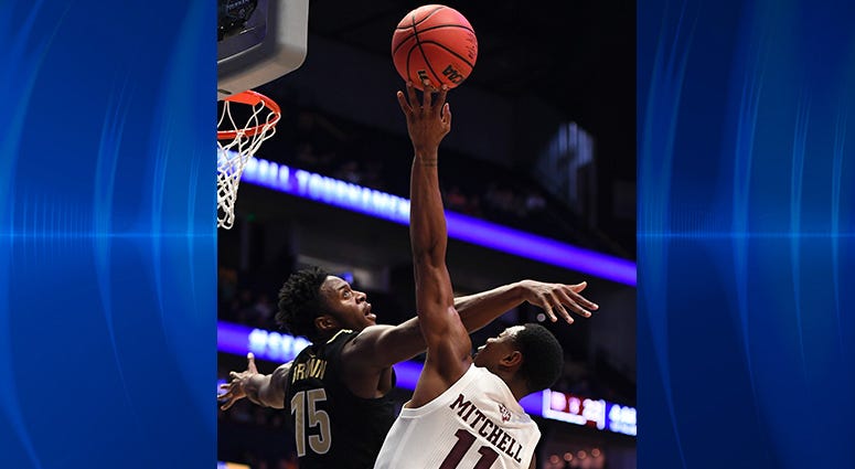 Texas A&M Aggies guard Wendell Mitchell (11) is fouled by Vanderbilt Commodores forward Clevon Brown (15) while shooting the ball during the first half of the SEC conference tournament at Bridgestone Arena. Texas A&M Aggies guard Wendell Mitchell (11) is fouled by Vanderbilt Commodores forward Clevon Brown (15) while shooting the ball during the first half of the SEC conference tournament at Bridgestone Arena.