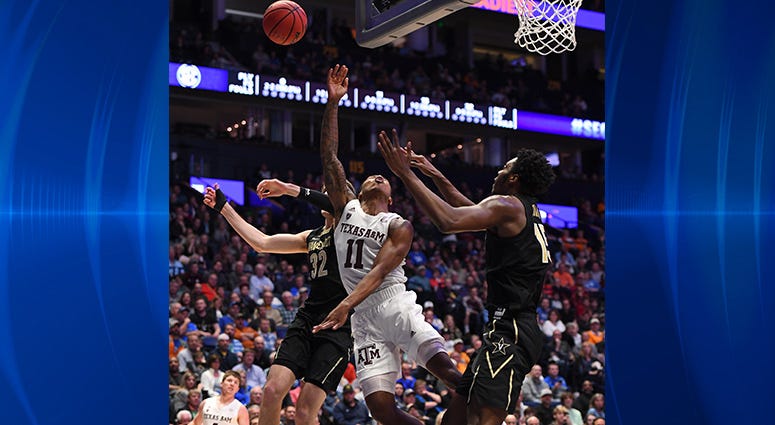 Texas A&M Aggies guard Wendell Mitchell (11) attempts to shoot the ball past Vanderbilt Commodores forward Matt Ryan (32) during the first half of the SEC conference tournament at Bridgestone Arena. Texas A&M Aggies guard Wendell Mitchell (11) attempts to shoot the ball past Vanderbilt Commodores forward Matt Ryan (32) during the first half of the SEC conference tournament at Bridgestone Arena.