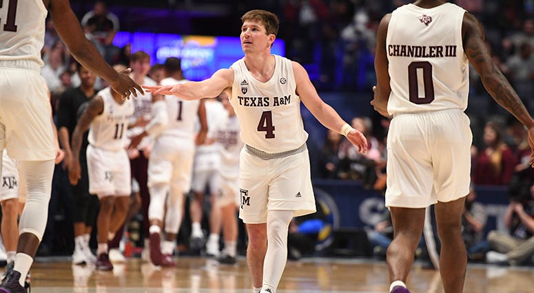 Texas A&M Aggies guard Mark French (4) celebrates with forward Christian Mekowulu (21) and guard Jay Jay Chandler (0) at the end of the first half of the SEC conference tournament at Bridgestone Arena. Texas A&M Aggies guard Mark French (4) celebrates with forward Christian Mekowulu (21) and guard Jay Jay Chandler (0) at the end of the first half of the SEC conference tournament at Bridgestone Arena.