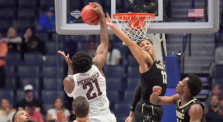 exas A&M Aggies forward Christian Mekowulu (21) and Vanderbilt Commodores forward Matthew Moyer (13) battle for the ball in the second half of the SEC conference tournament at Bridgestone Arena. exas A&M Aggies forward Christian Mekowulu (21) and Vanderbilt Commodores forward Matthew Moyer (13) battle for the ball in the second half of the SEC conference tournament at Bridgestone Arena.