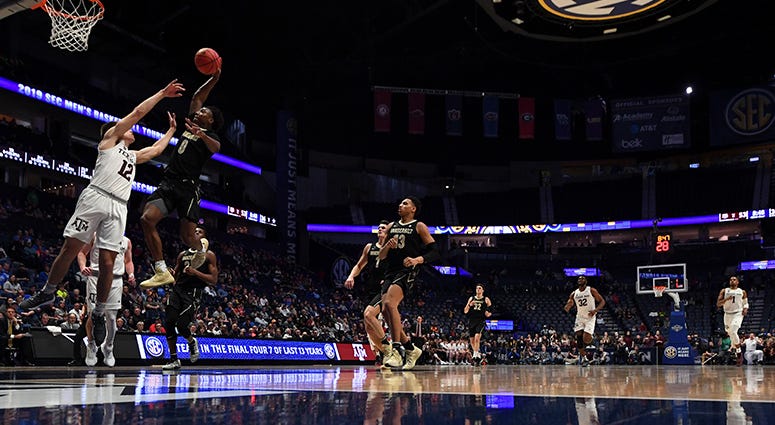 Vanderbilt Commodores guard Saben Lee (0) dunks the ball over Texas A&M Aggies guard Chris Collins (12) during the second half of the SEC conference tournament at Bridgestone Arena. Vanderbilt Commodores guard Saben Lee (0) dunks the ball over Texas A&M Aggies guard Chris Collins (12) during the second half of the SEC conference tournament at Bridgestone Arena.