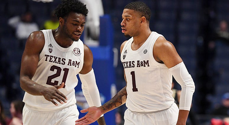 Texas A&M Aggies forward Christian Mekowulu (21) and Texas A&M Aggies guard Savion Flagg (1) celebrate in the final minutes of a win against the Vanderbilt Commodores in the SEC conference tournament at Bridgestone Arena. Texas A&M Aggies forward Christian Mekowulu (21) and Texas A&M Aggies guard Savion Flagg (1) celebrate in the final minutes of a win against the Vanderbilt Commodores in the SEC conference tournament at Bridgestone Arena.