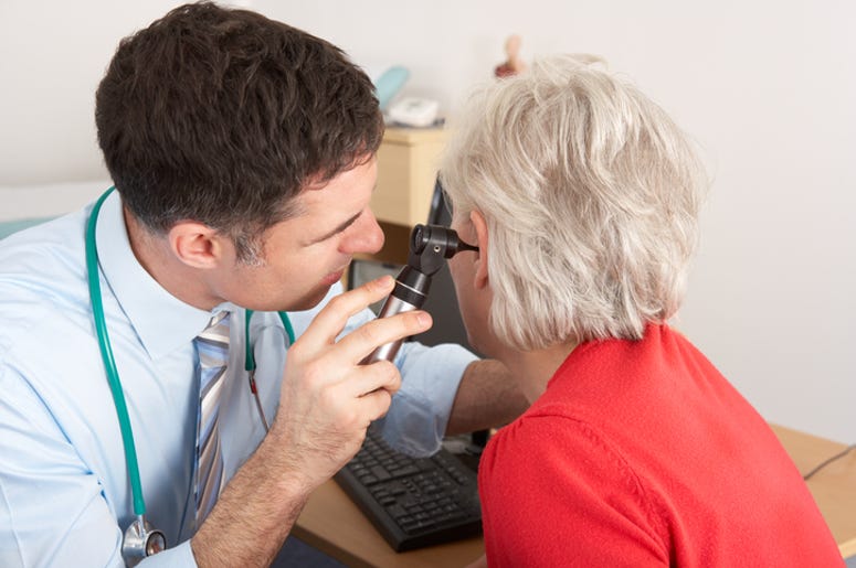 Doctor Looking At A Patients Ear