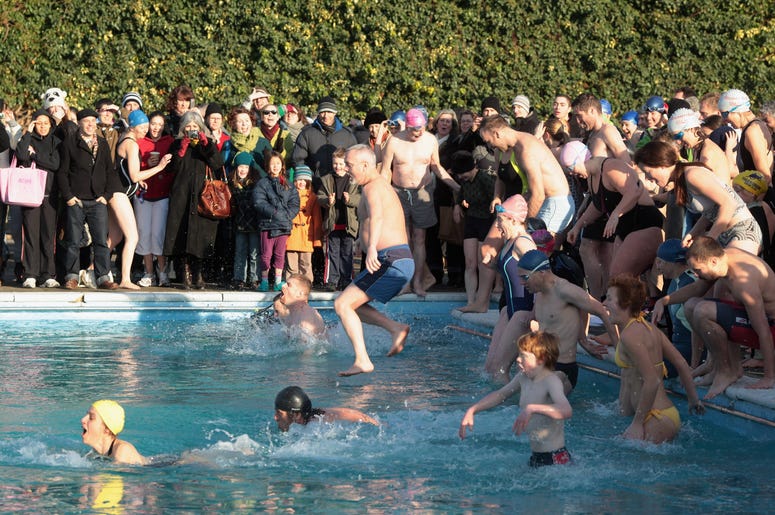 People Jumping into a freezing pool