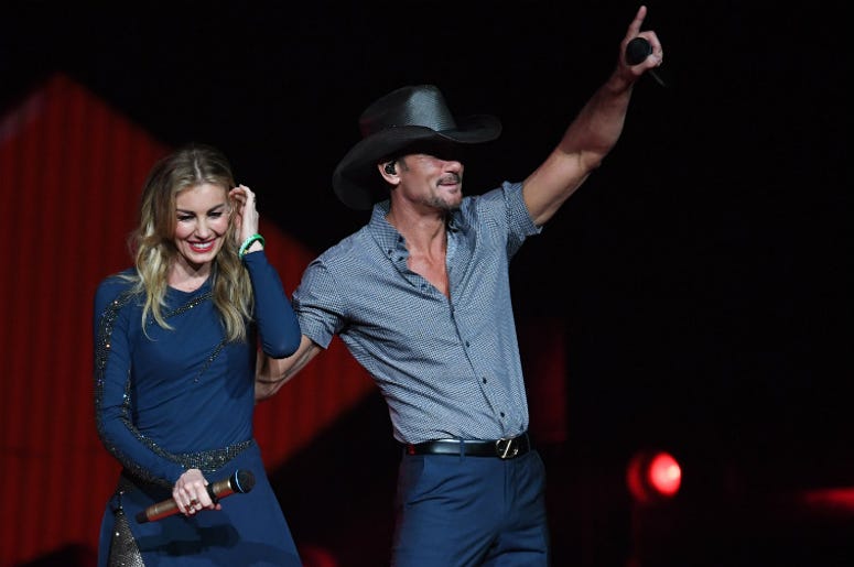Tim McGraw and Faith Hill performing onstage. 100.3 Jack FM,Tim McGraw,Faith Hill,Collapse,Onstage,Concert,Music,Country,Health,Dehydration