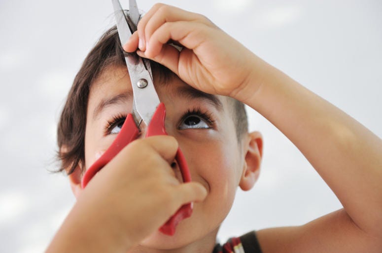 Boy Cutting His Hair